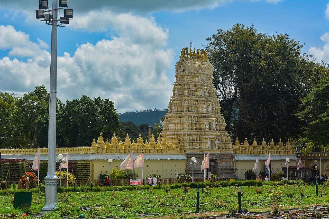 The seven-storey gopura of the Sri Chamundeshwari temple rising over its compound wall on Chamundi Hill, Mysuru